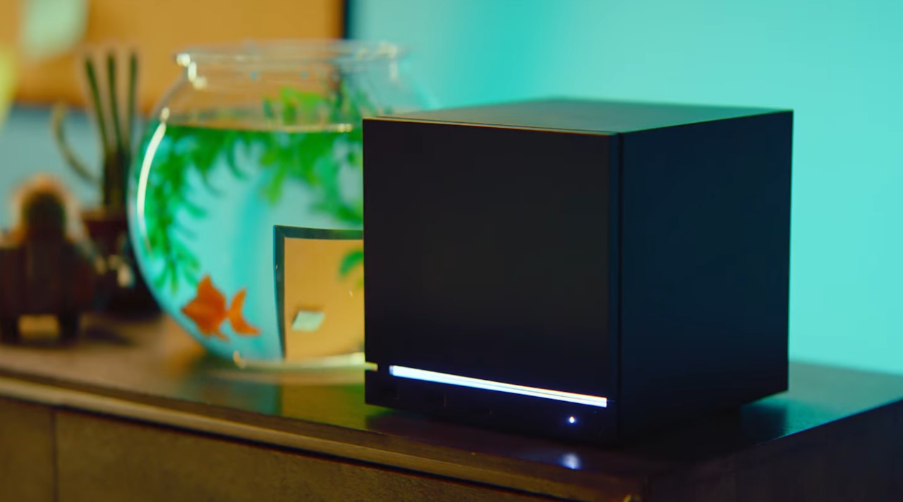 Promo image of the Steam Machine on a desk next to a fishtank.