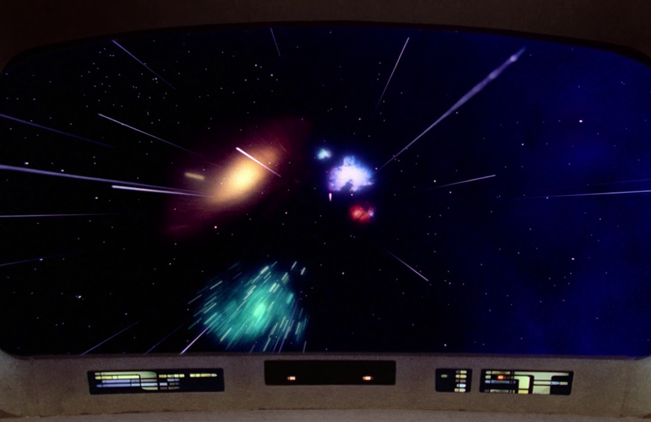 Still frame from Star Trek: The Next Generation showing the viewscreen and galaxies.