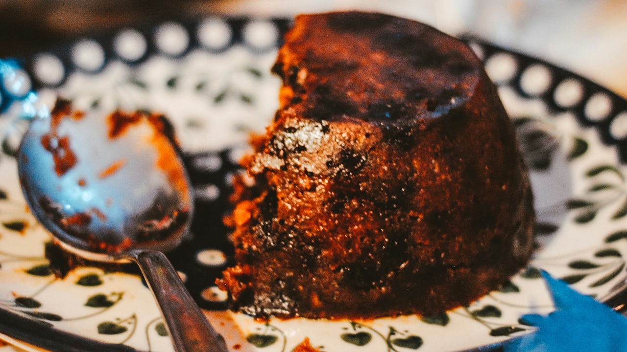 Stock photo of a (half-eaten) Christmas pudding.