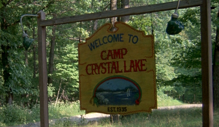 Still frame from Friday the 13th showing the Camp Crystal Lake sign.