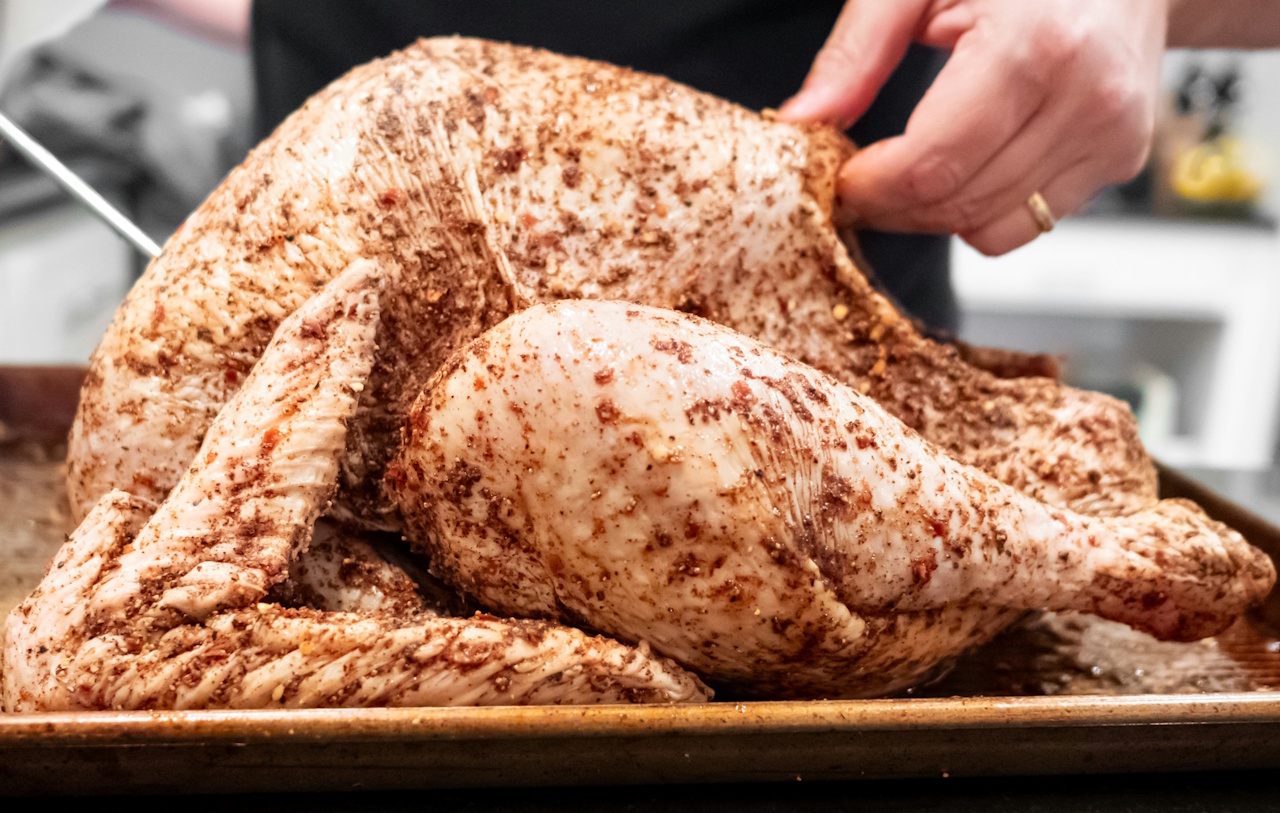 Stock photo of a raw turkey being prepared for cooking.
