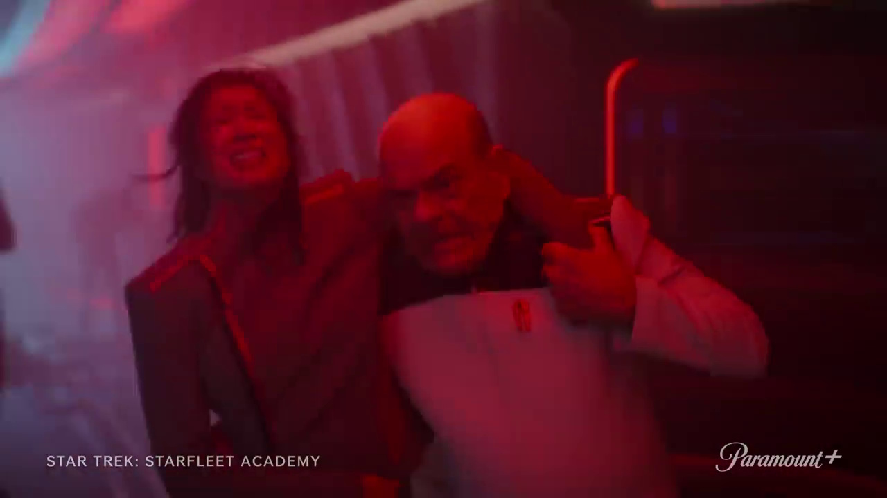 Still frame from the Star Trek: Starfleet Academy promotional clip showing the Doctor assisting an injured colleage.