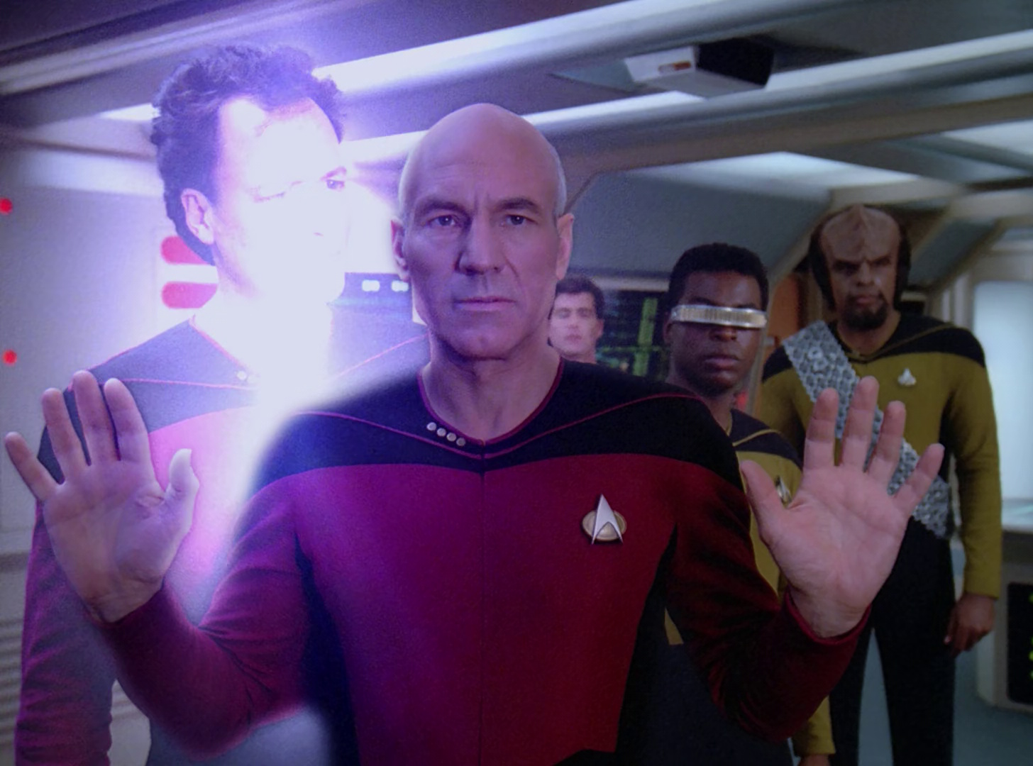 Still frame from Star Trek: The Next Generation Season 2 (Q Who) showing Q materialising next to Picard.