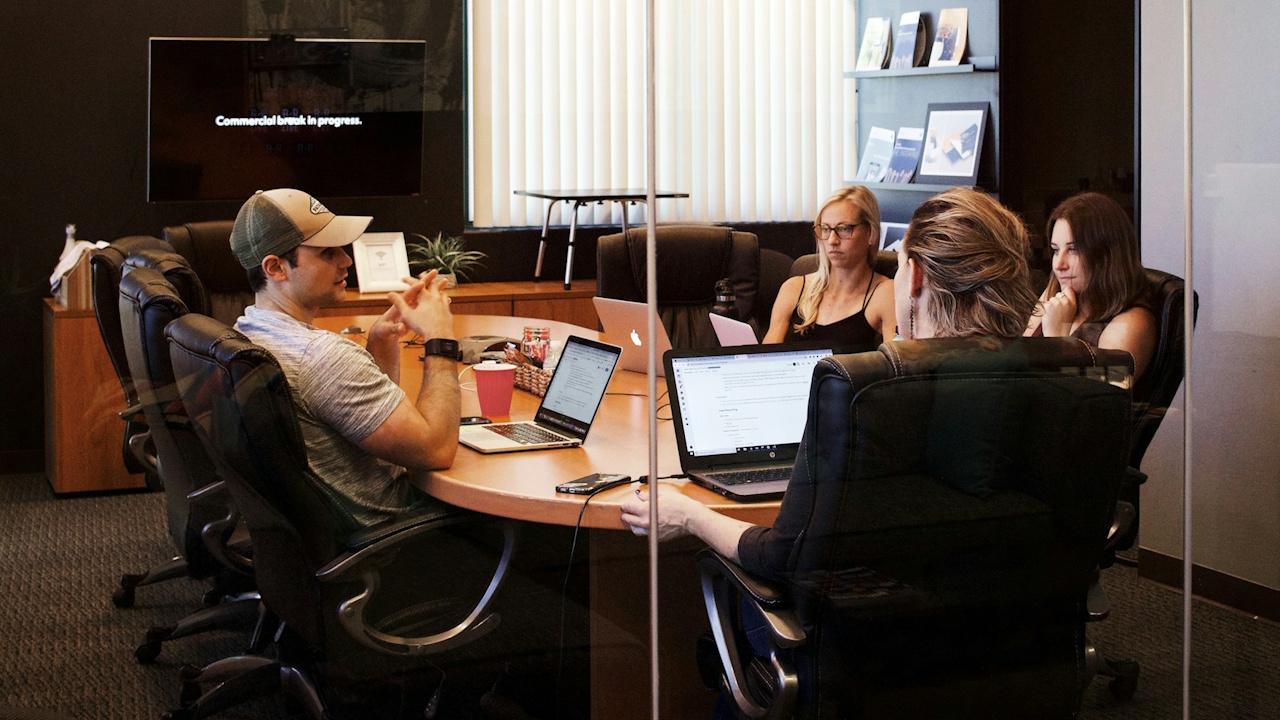 Stock photo of people in a meeting room at an office.