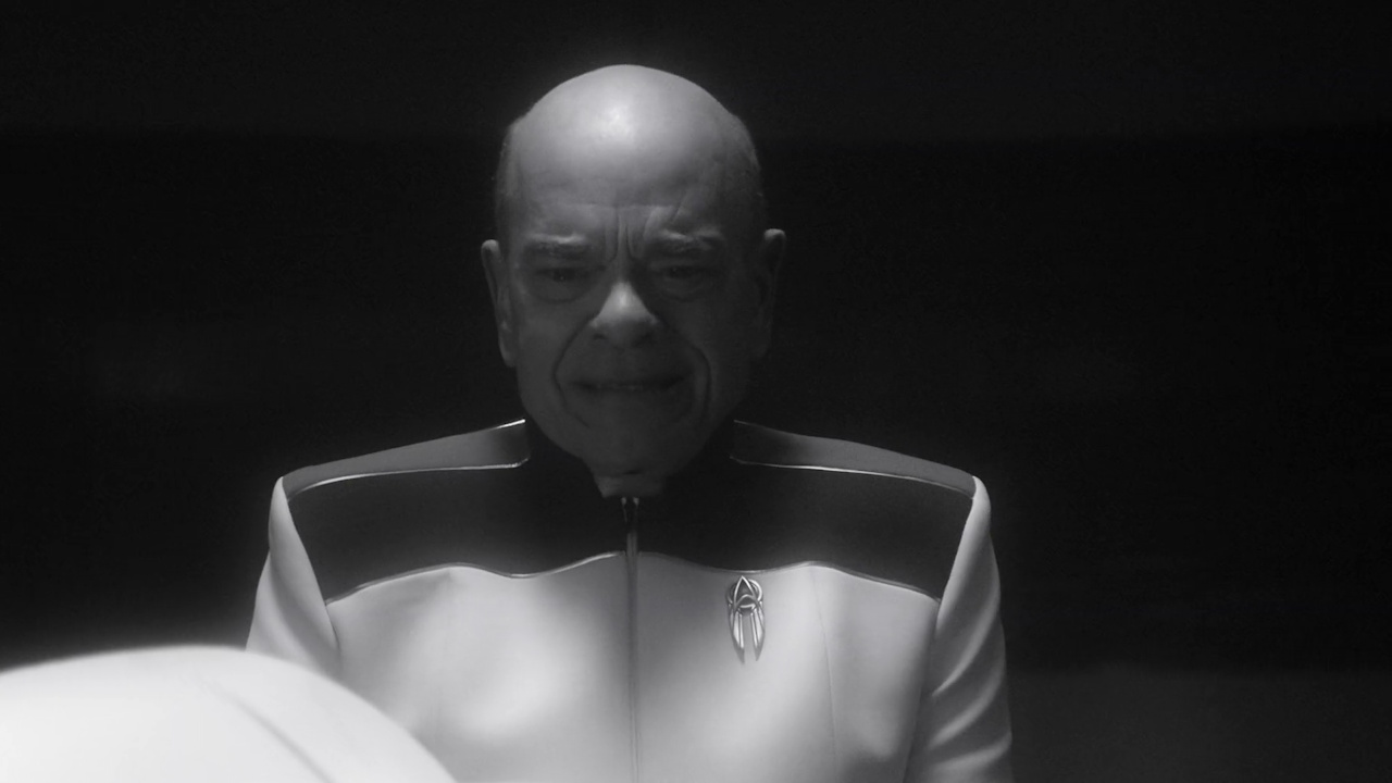Still frame from Star Trek SFA 1x08 showing the Doctor getting emotional
