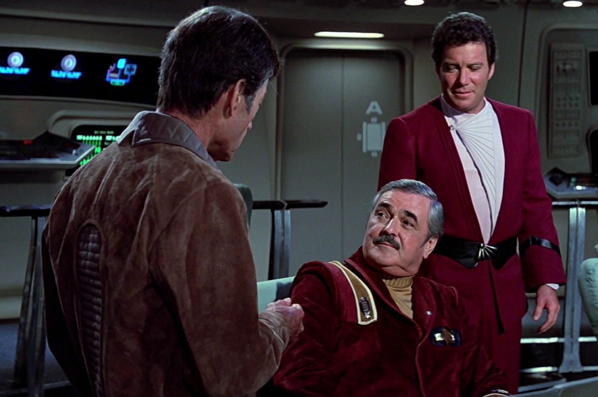 Still frame from Star Trek III showing Scotty with Kirk and McCoy