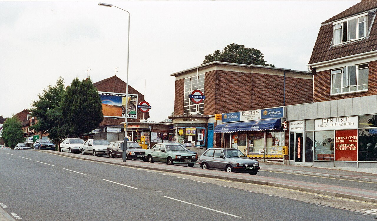 A photo of cars parked outside a railway station in the UK in 1991