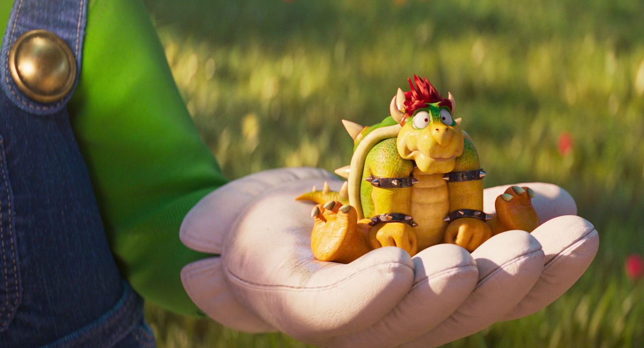 Still frame from The Super Mario Galaxy Movie (2026) showing mini Bowser in Luigi's hand