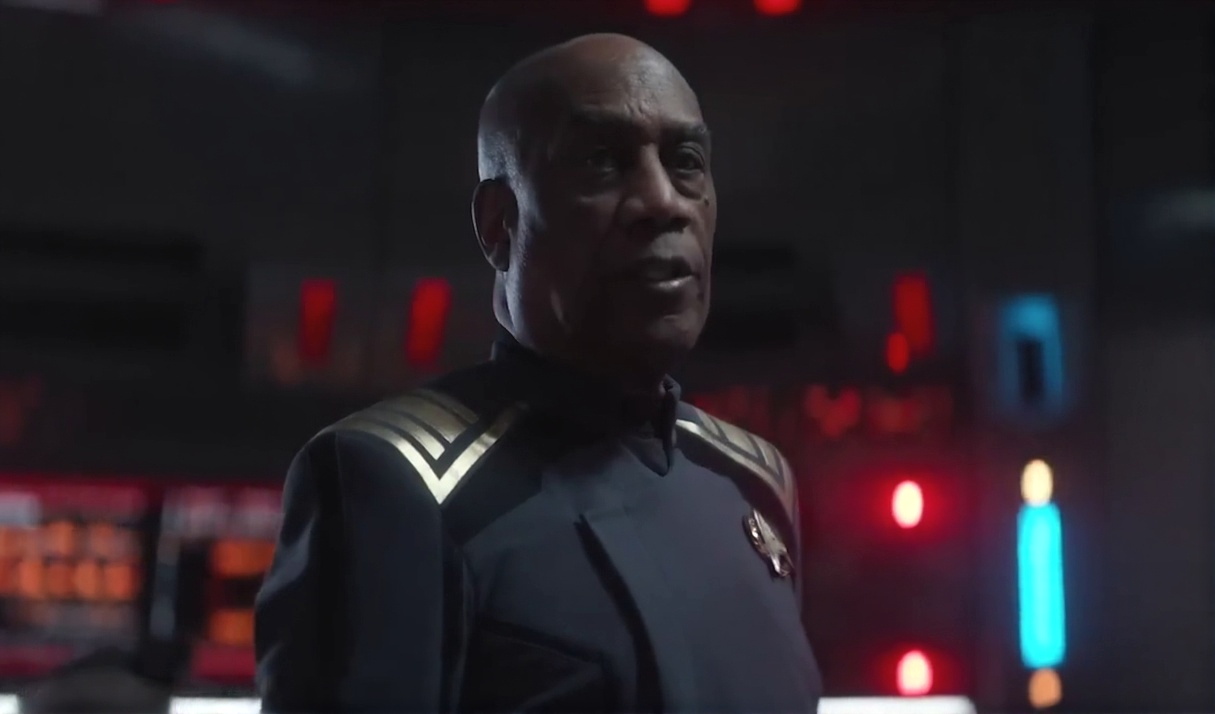 Still frame from the Star Trek SNW S4 trailer showing an admiral