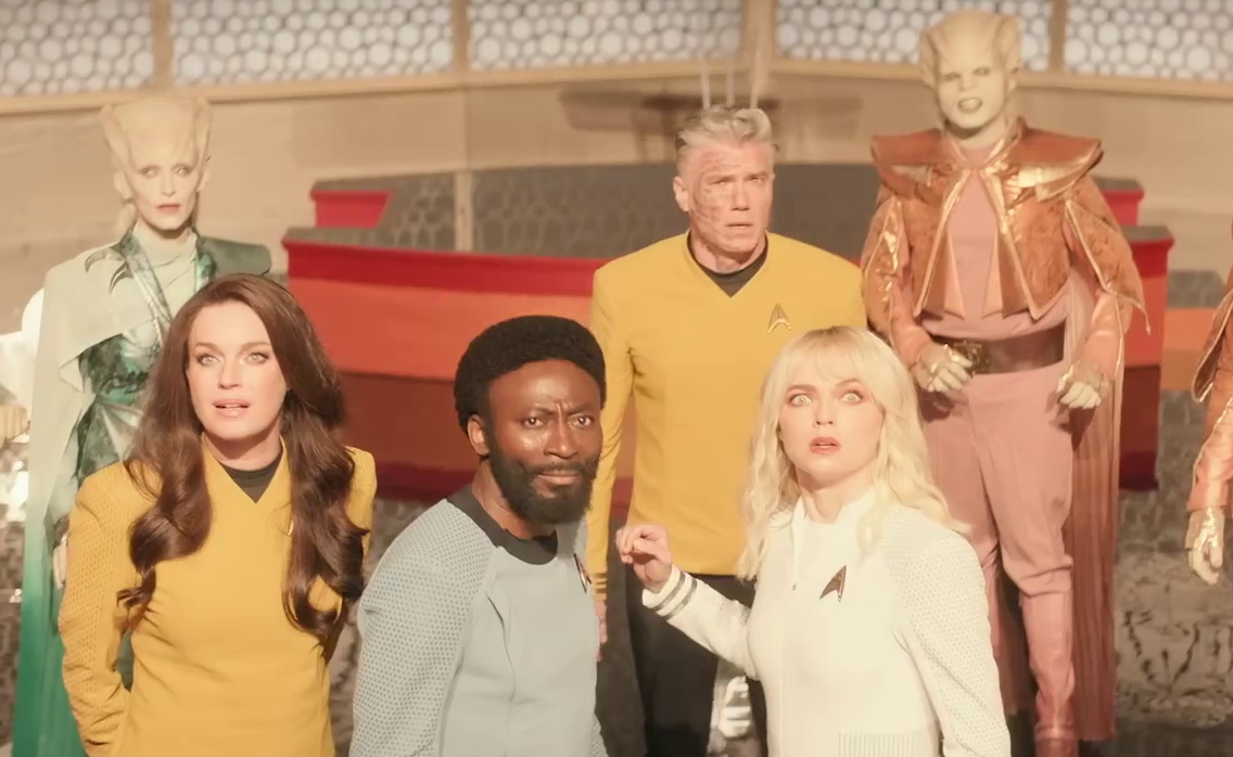 Still frame from the Star Trek SNW S4 trailer showing Pike with the crew and aliens