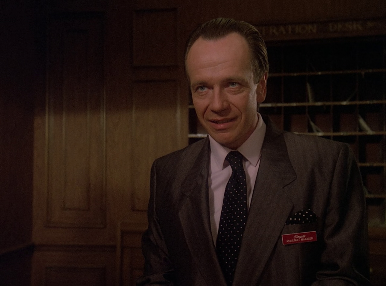 Still frame from Star Trek TNG The Royale showing the assistant manager