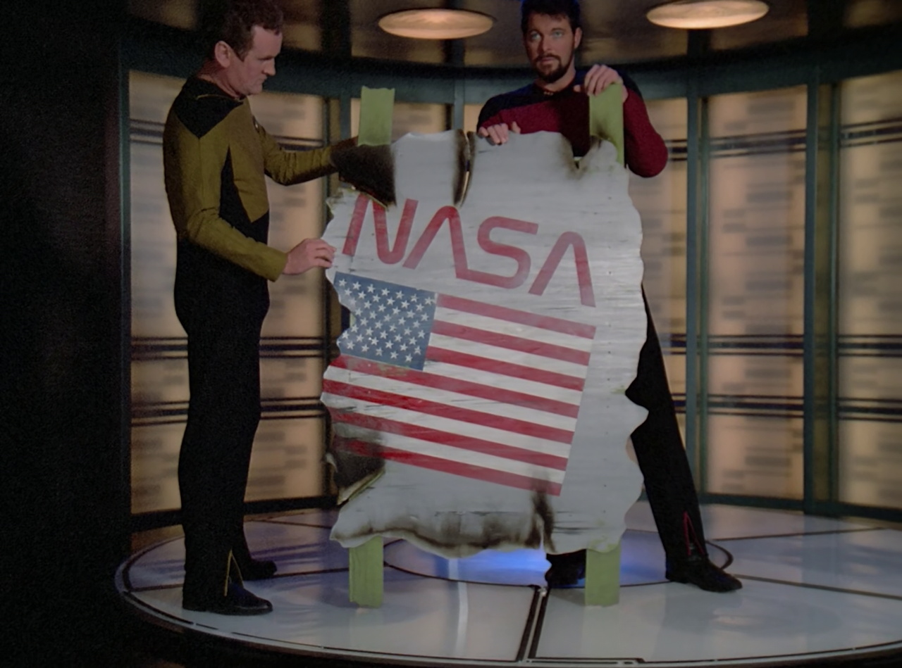Still frame from Star Trek TNG The Royale showing O'Brien and Riker with the NASA debris