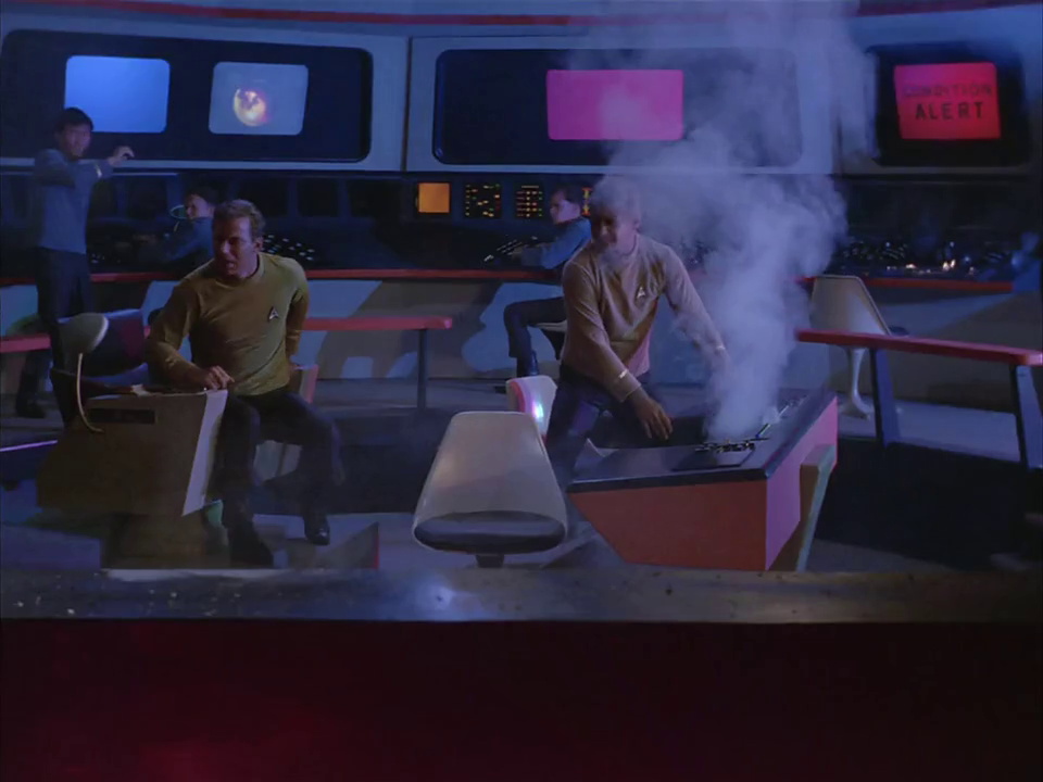 Still frame from Star Trek TOS showing the bridge and smoke