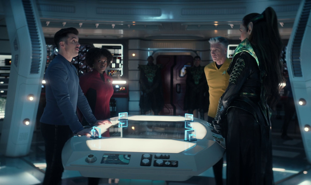 Still frame from Strange New Worlds 4x01 showing Pike, Sam, Uhura, and Cassell