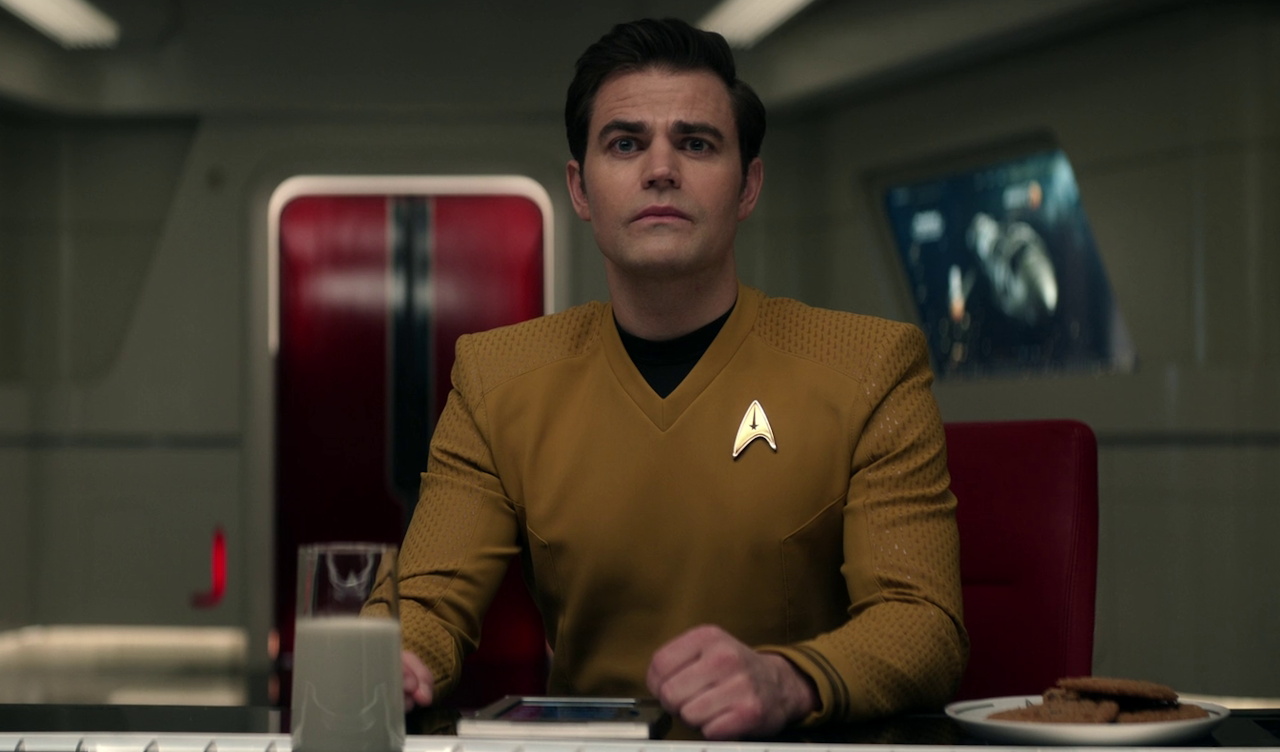 Still frame from Star Trek SNW 4x02 showing Kirk with milk and cookies