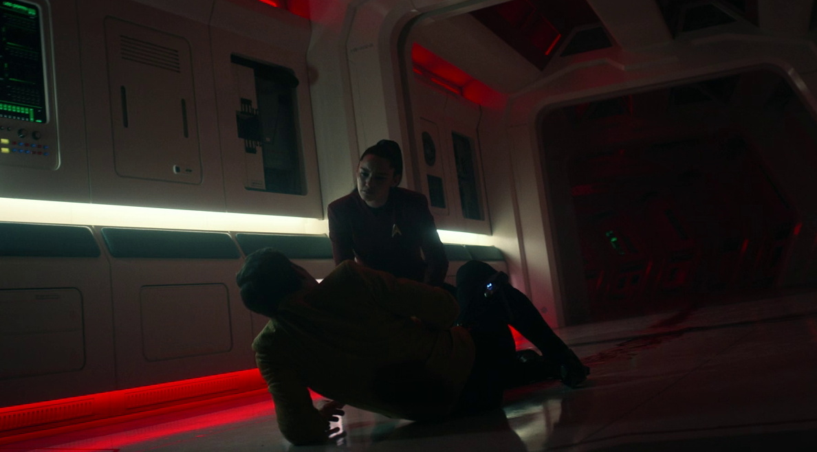 Still frame from Star Trek SNW 4x02 showing La'an and an injured Kirk