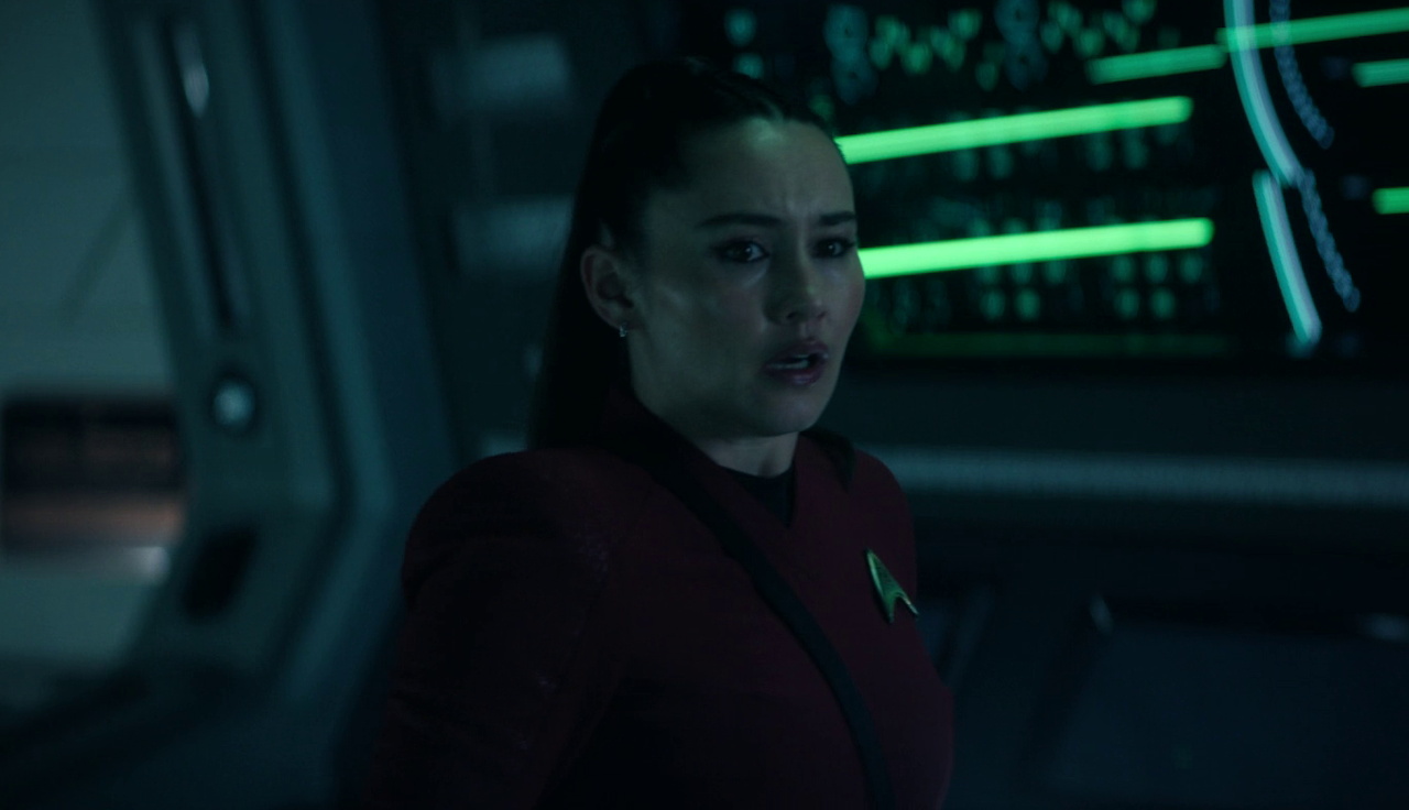 Still frame from Star Trek SNW 4x02 showing La'an looking shocked