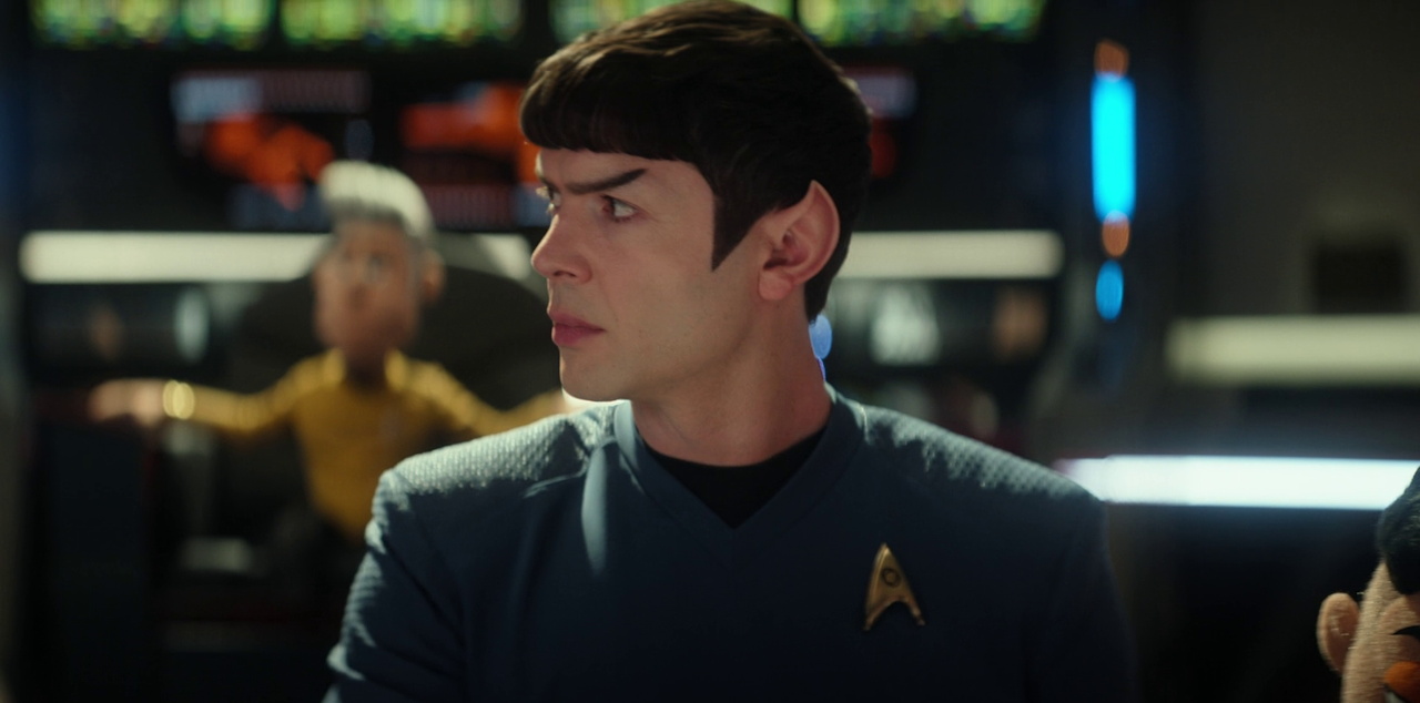 Still frame from Star Trek SNW 4x05 showing Spock with puppet Pike in the background