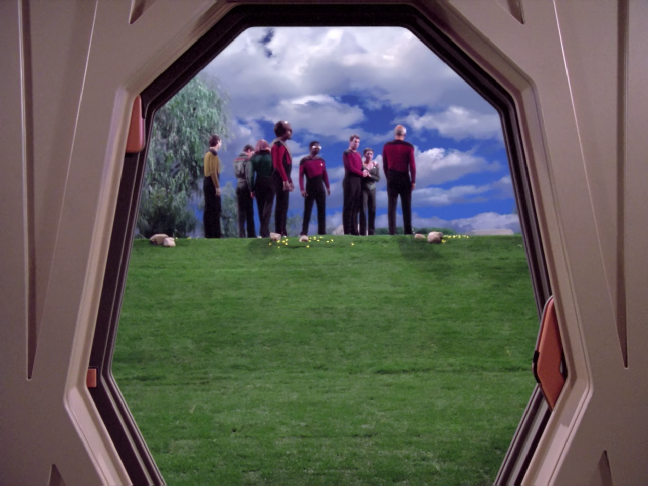 till frame from Star Trek TNG 1x22 showing the funeral and the holodeck doors