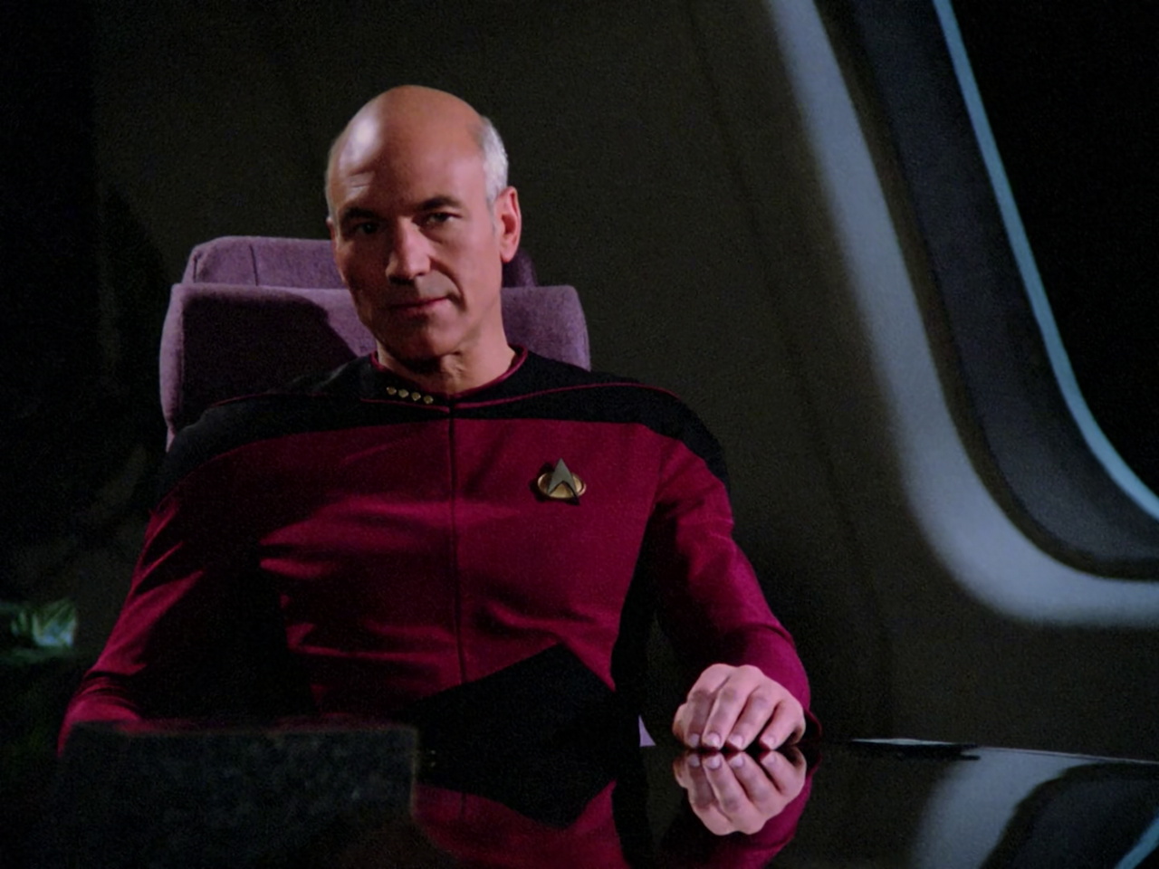 till frame from Star Trek TNG 1x22 showing Picard in the Briefing Lounge