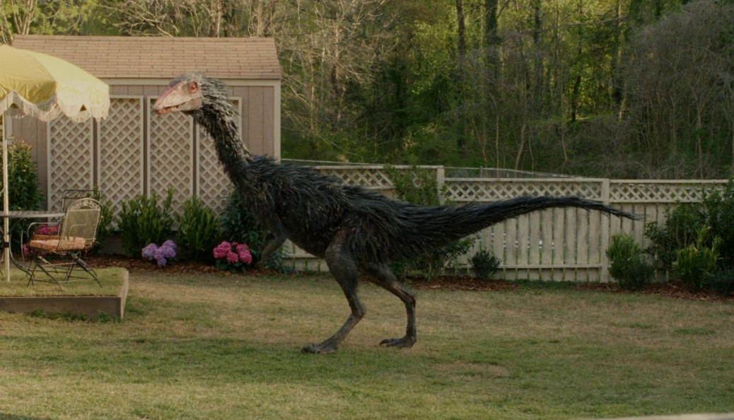 Still frame from The End of Oak Street (2026) showing a feathered dinosaur