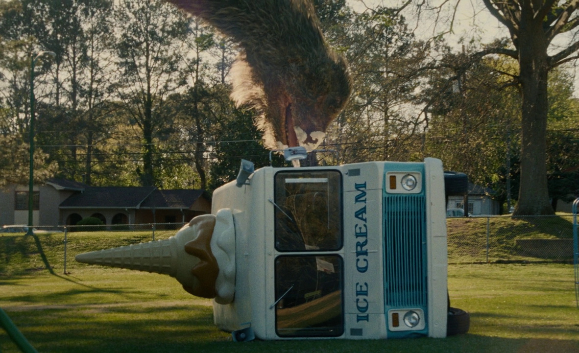 Still frame from The End of Oak Street (2026) showing a dinosaur eating ice cream (no, really)