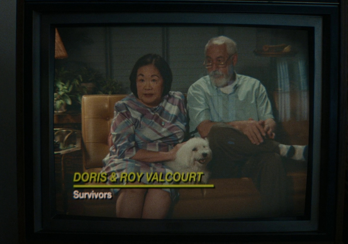 Still frame from The End of Oak Street (2026) showing survivors on a CRT TV