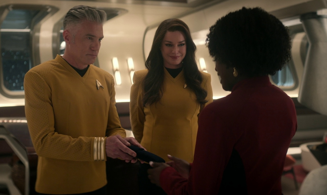 Still frame from Star Trek SNW 4x08 showing Pike and Una promoting Uhura