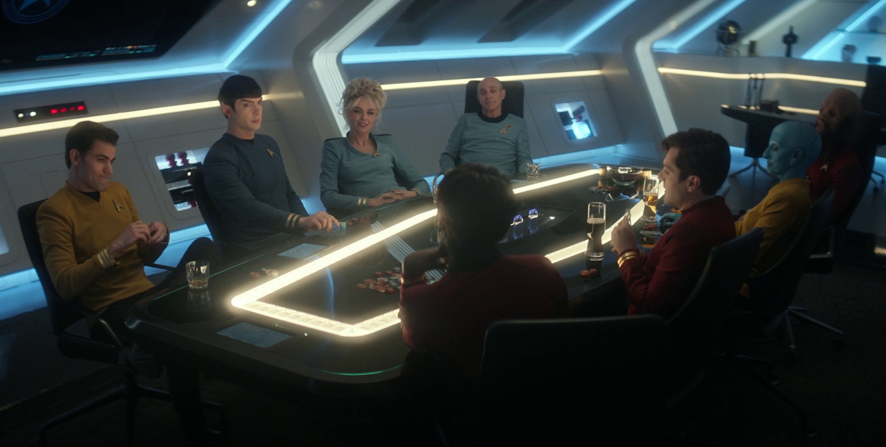 Still frame from Star Trek SNW 4x10 showing Kirk, Chapel, Spock, Boyce, Uhura, and Scotty at the poker game