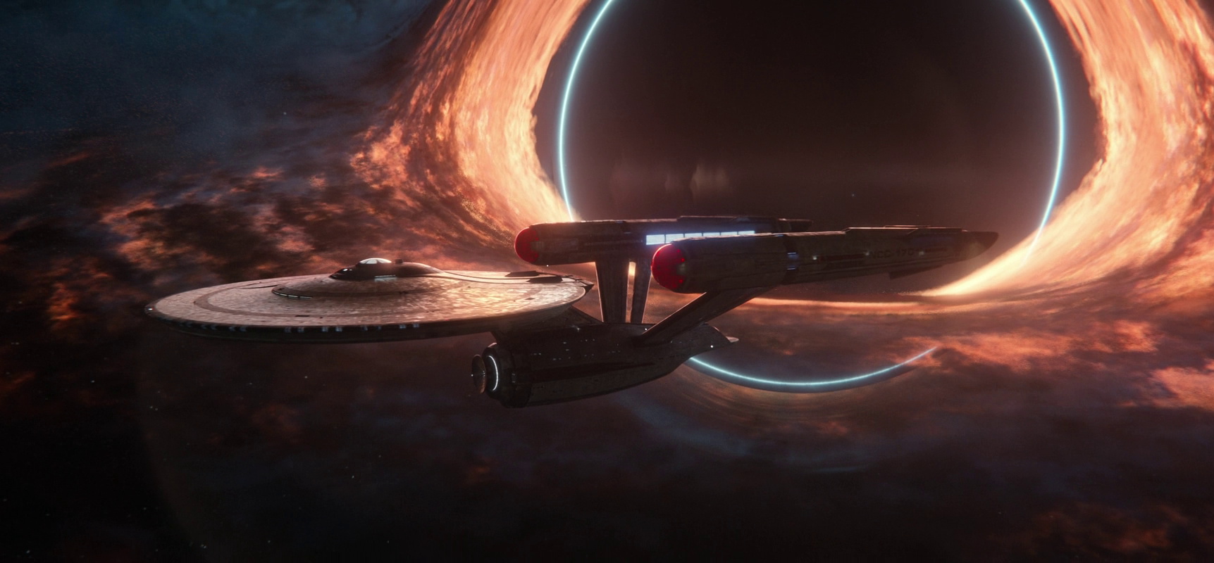 Still frame from Star Trek SNW 4x10 showing the USS Enterprise by a black hole