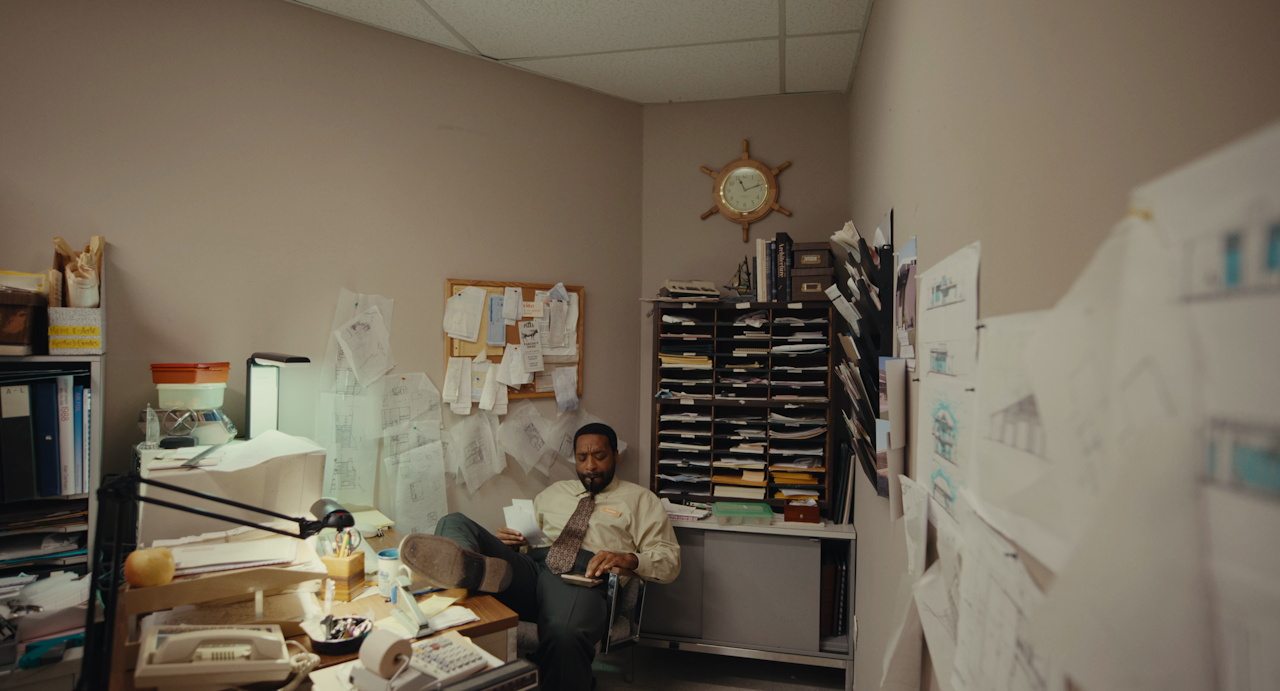 Still frame from Backrooms (2026) showing Clark in his office