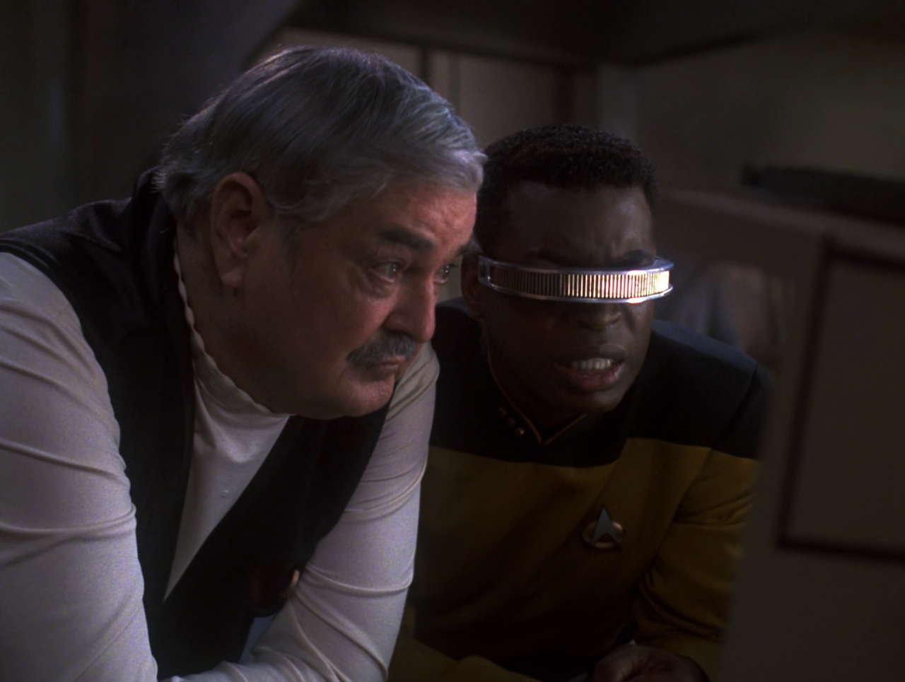 Still frame from Star Trek TNG Relics showing Scotty and Geordi in close-up